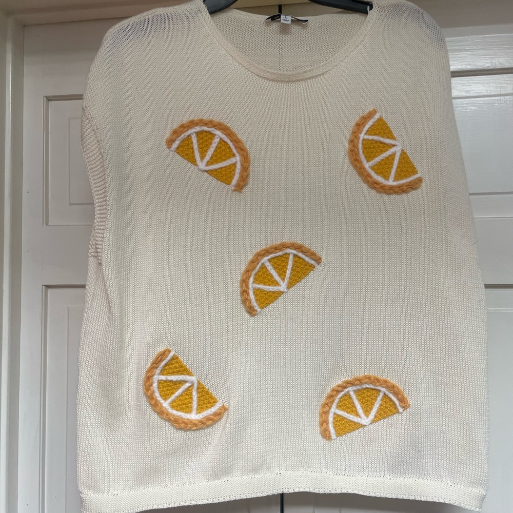 Cream sleeveless Sweater with Orange/lemon Slice Design. Size large